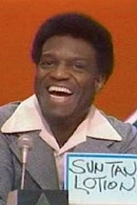 Nipsy Russell on Match Game, revealing his answer, written in blank marker on a card. 

It says "SUNTAN LOTION".