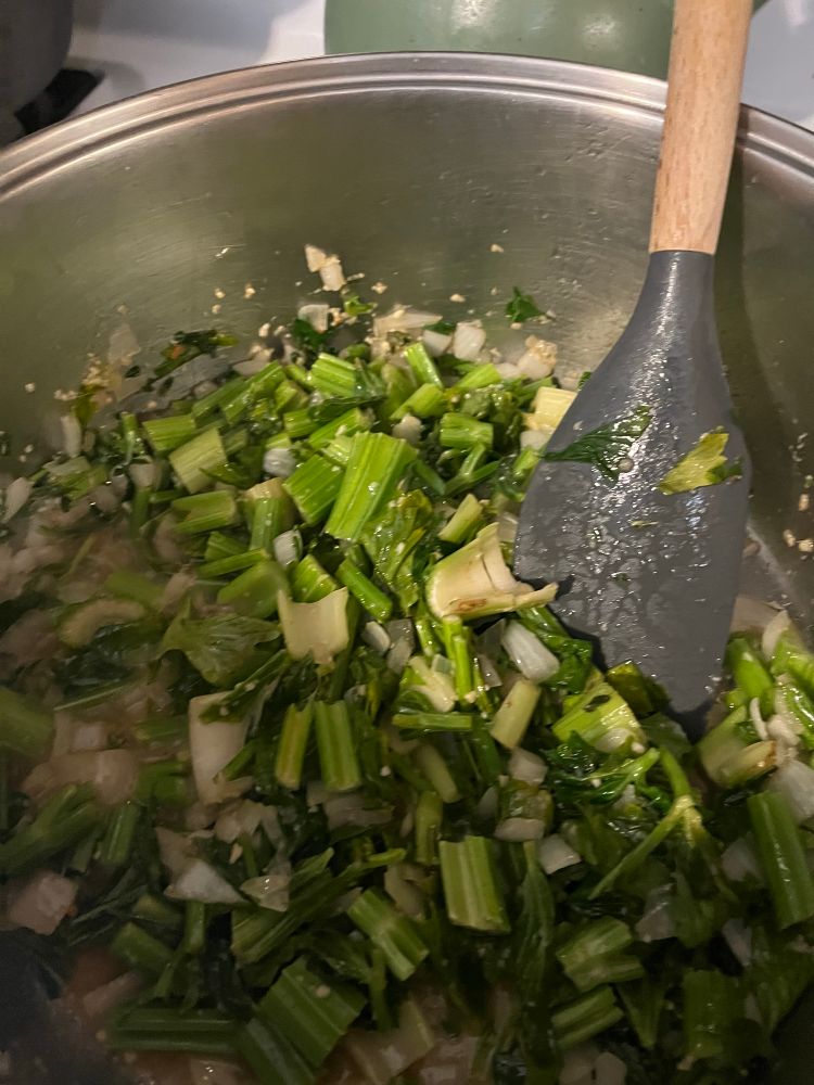 Lovely fresh celery (including leaves), onions, garlic, and fresh thyme being sautéed.