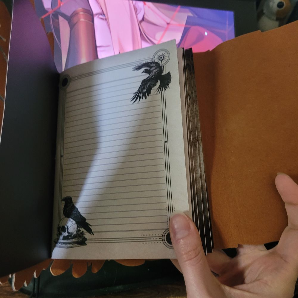 The pages in the notebooks feature lines and two crow images: one of a crow in flight, and one of a crow perched atop a skull.