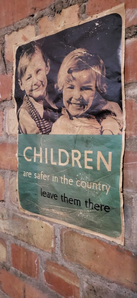 Old wartime poster showing a young boy and girl with the slogan Children are safer in the country leave them there.