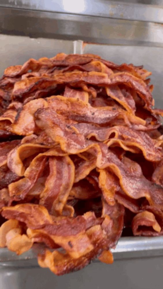 a large pile of bacon is sitting on a tray