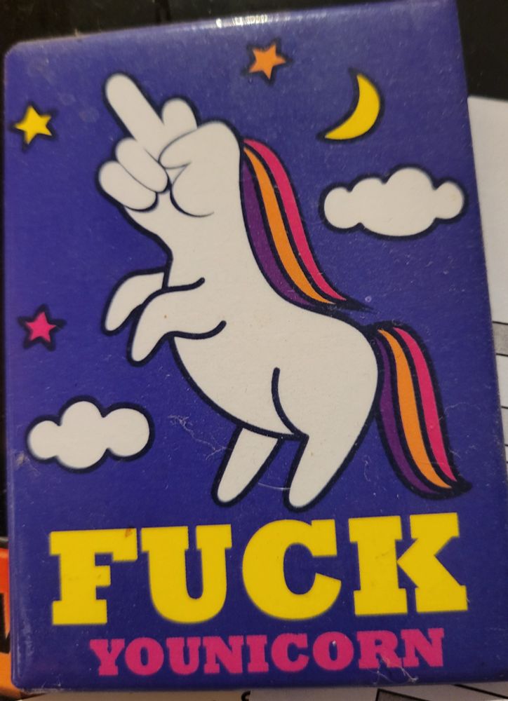 A unicorn like creature with a middle finger on its head. Purple background
