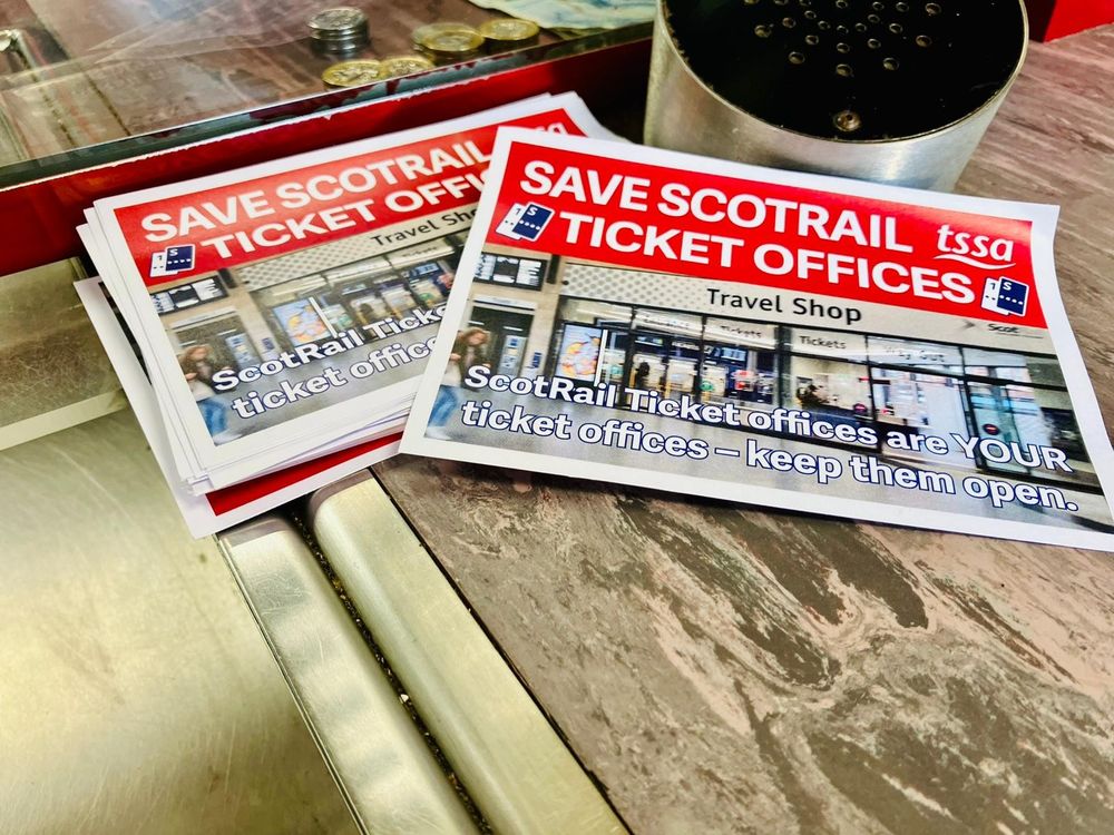 A picture of #SaveScotRailTicketOffices leaflets on the ticket office desk.