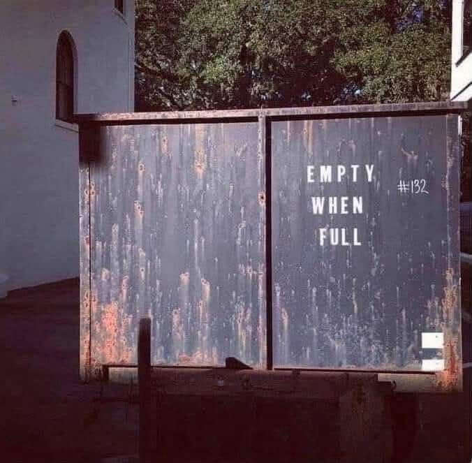 A dumpster with the words “Empty When Full” stenciled on the side.