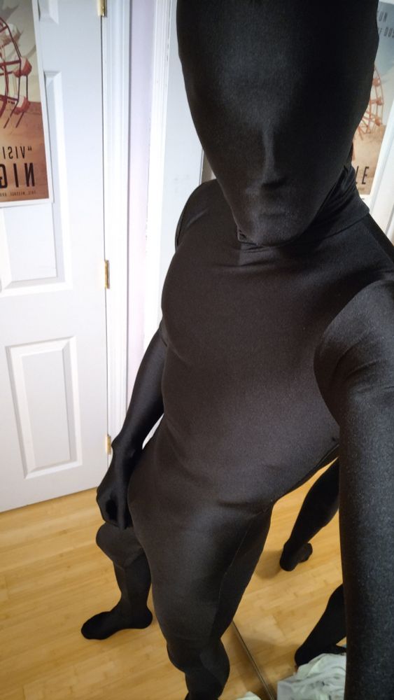 Standing, three-quarter view to camera wearing my custom sized black zentai suit