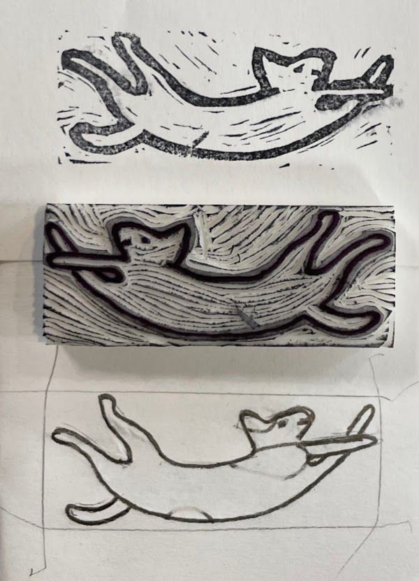 Making a rubber stamp, in three pictures. The stamp is of a smiling, stretched-out cat. The bottom of the picture shows the sketch, inside an outline of the eraser. The middle shows the stamp itself, already carved out. The top shows the stamp used on paper. 