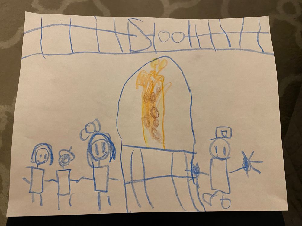A 5 year old’s drawing in crayon of a scene of people looking at a giraffe at a zoo. The people are drawn in blue crayon, the zoo enclosure is drawn in blue crayon, and the giraffe is drawn in classic yellow and brown giraffe colors. 