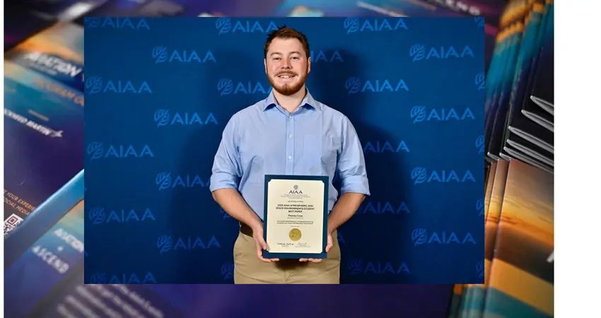 Thomas Cross with his award