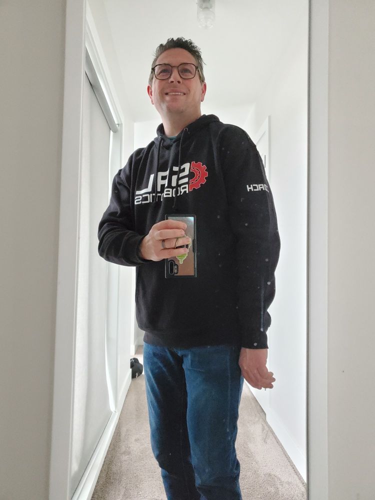 Wearing a hoodie with a Sal Robotics and on the side saying coach