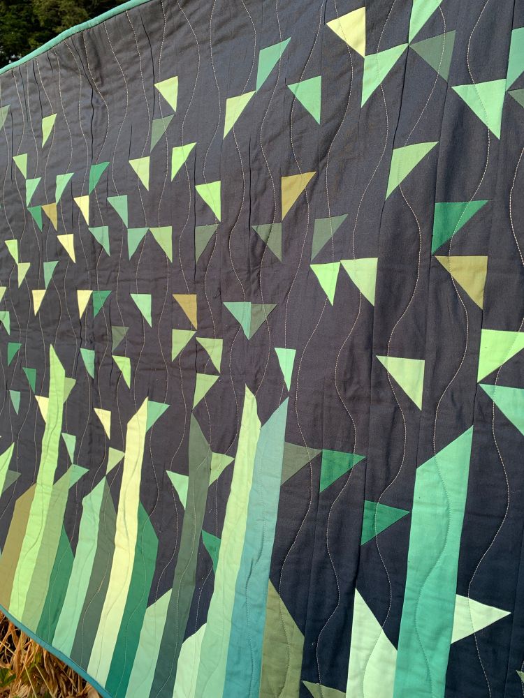 A closeup of the quilt, showing the wavy quilting, which makes it look a little like an underwater scene