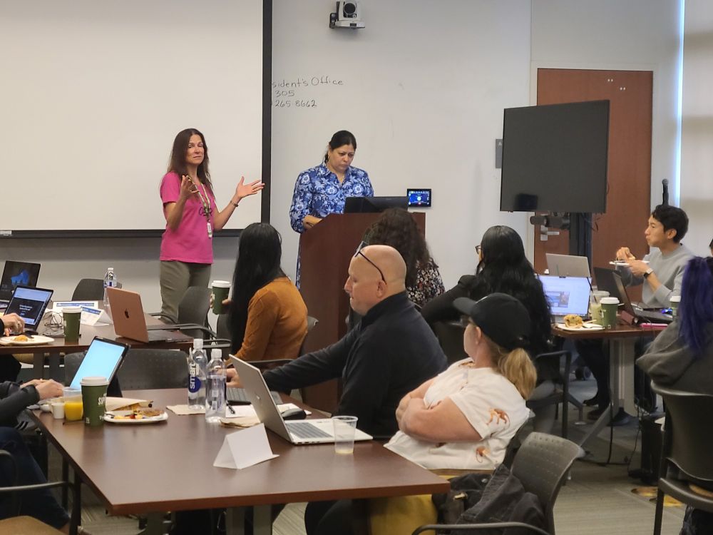 OERI team members preparing to present in front of a room of workshop participants 