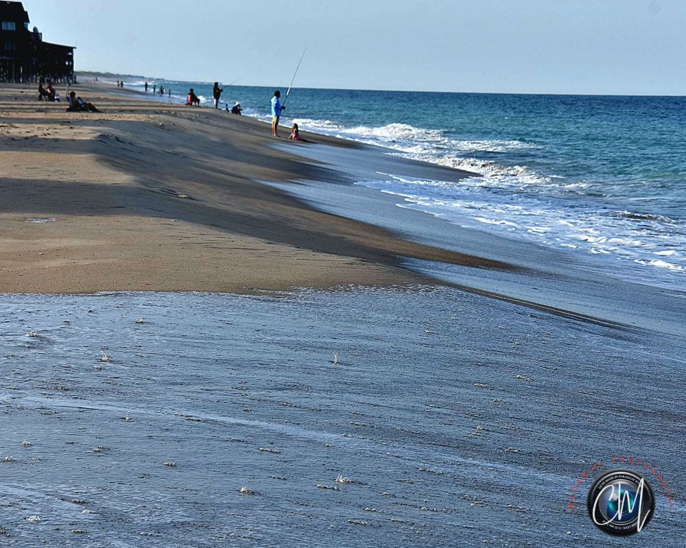 Shoreline in the Outer Banks in Buxton, NC. People are fishing in the distance.
