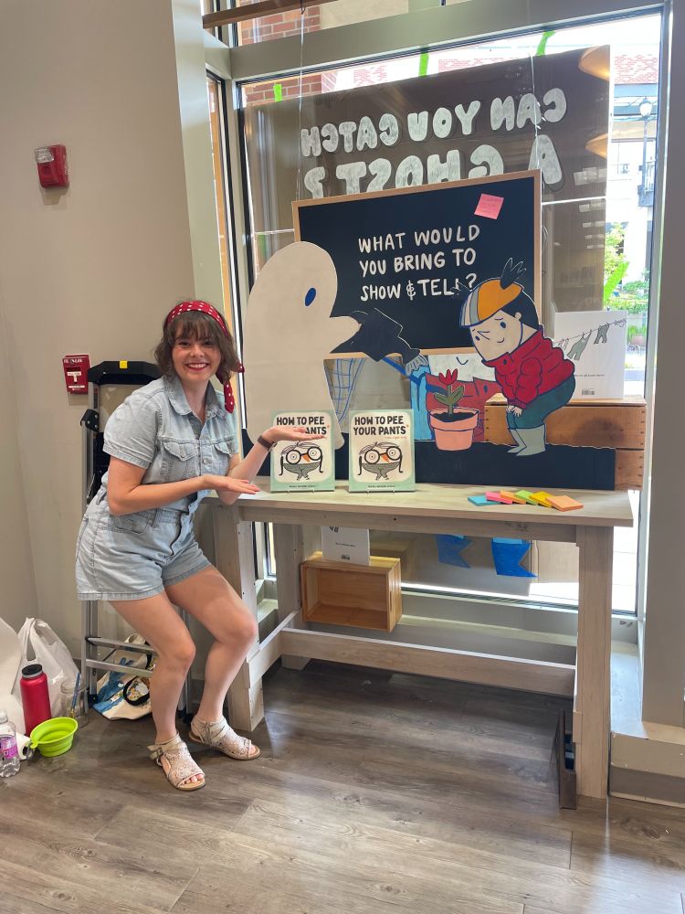Rachel Michelle Wilson poses in front of her window display at Brick & Mortar Books.
