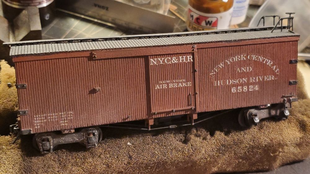 NYC&HR boxcar 65824 in brown with fox patent trucks and double roof railings.