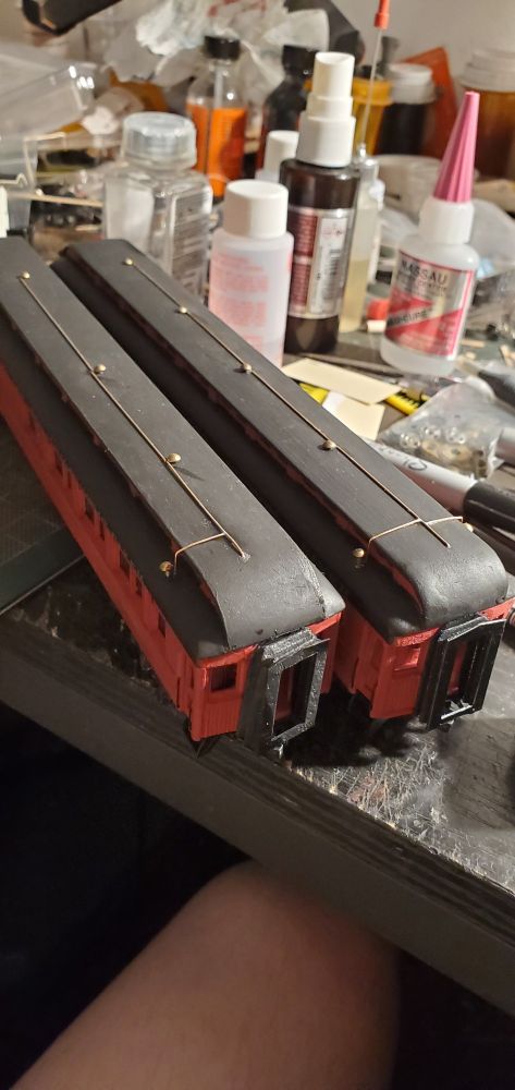 Two 60' Labelle wood coached with gas light piping on the roof. 