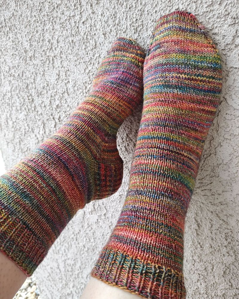 Variegated socks in a rainbow of colors, with an overall autumn feel to the tones.