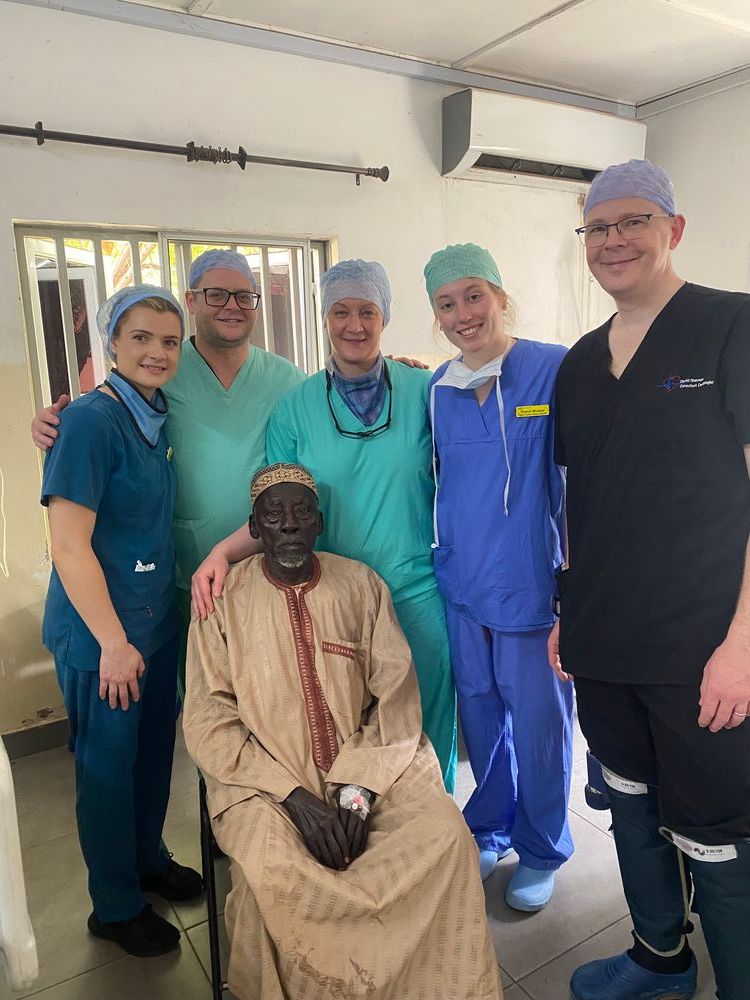 Niamh and other healthcare staff alongside a patient.