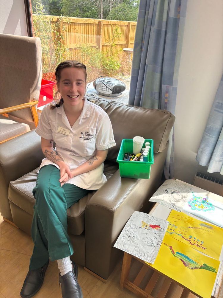 Occupational therapy student Rachel among art supplies.