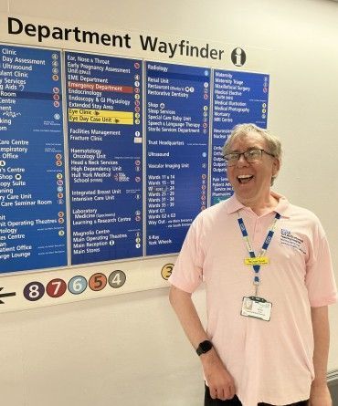 Michael standing in front of a hospital sign.
