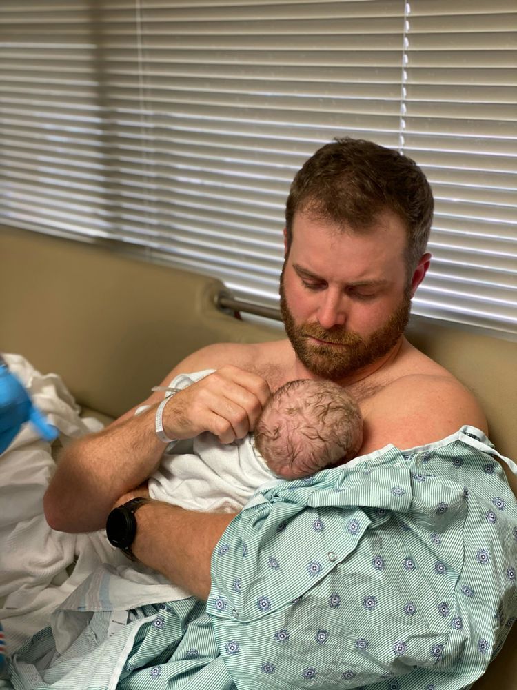 A man holding a newborn baby.