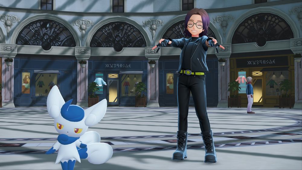 A picture from Legends: Za. In it is my character and Meowstic in the middle of a shopping center. My character is wearing green glasses, a black leather jacket/turtleneck, black gloves, black skinny jeans, and black boots. He is posing for the camera holding two peace signs angled towards the camera and downward.