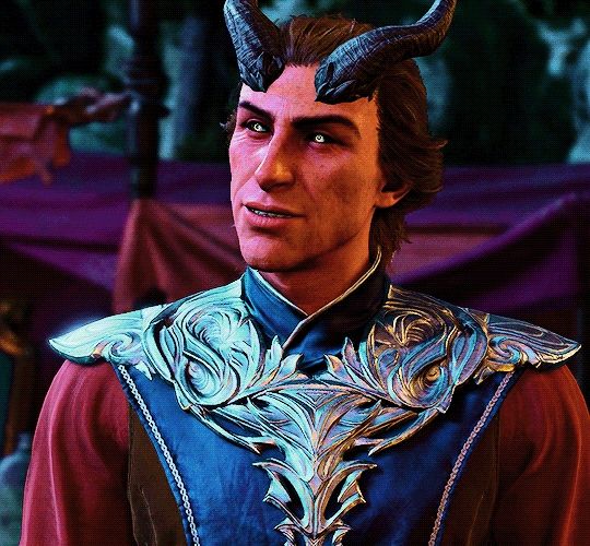 Rolan is talking to someone. Only pictured is Rolan. He is in his blue, red and silver wizard robes. Only pictured is from his chest up. He is smiling and seems happy. His golden eyes are wide and glowing. His eyes crinkle on the sides. His brown hair is pulling back as normal, hiding his ears except for a small point. His two curved black horns are on his head as normal. Lightly shown is his freckles all over his face and neck. Tents are shown behind him.