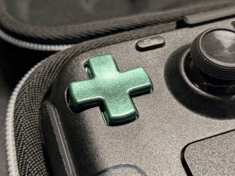 Close-up of a custom made green d-pad in a Steamdeck