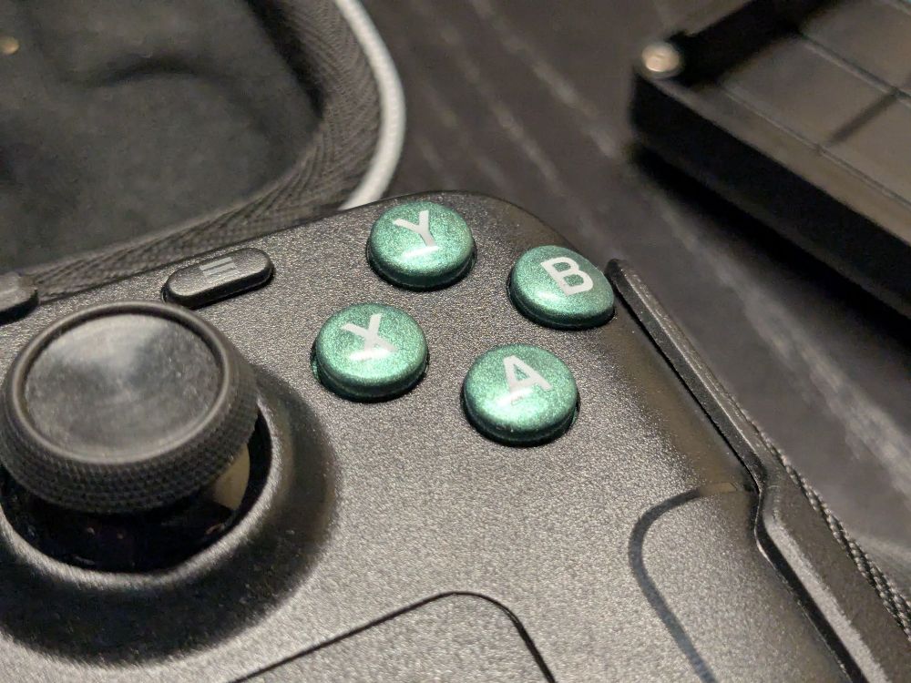 Close-up of custom made green action buttons in a Steamdeck