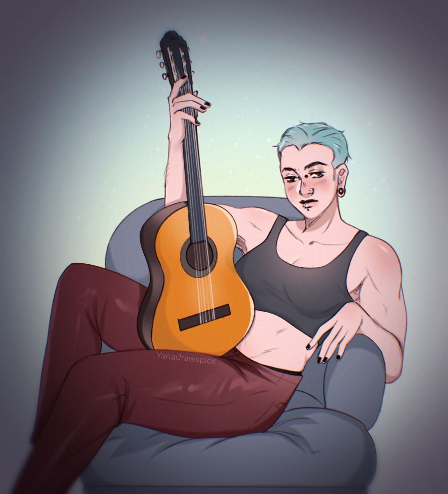 A butch woman sitting in a chair with a guitar on her lap 