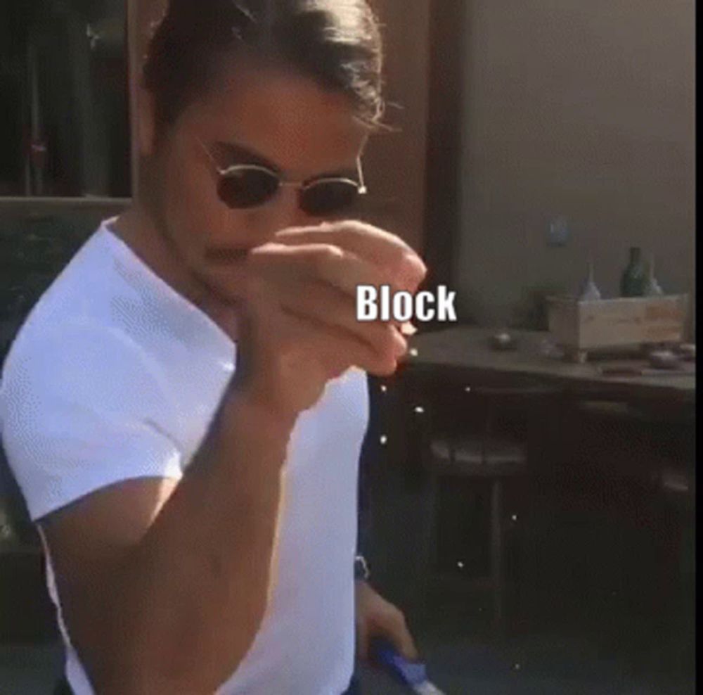 a man wearing sunglasses and a white shirt with the word block written on it