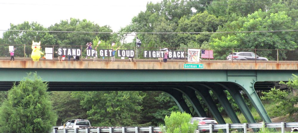 Gorman Rd/I-95 overpass with a large sign that says “Stand Up Get Loud Fight Back.” 
