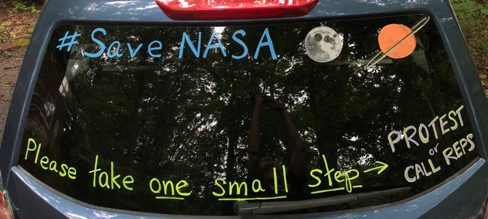 Message on a car rear window reads #SaveNASA, Please take one small step—protest or call reps.