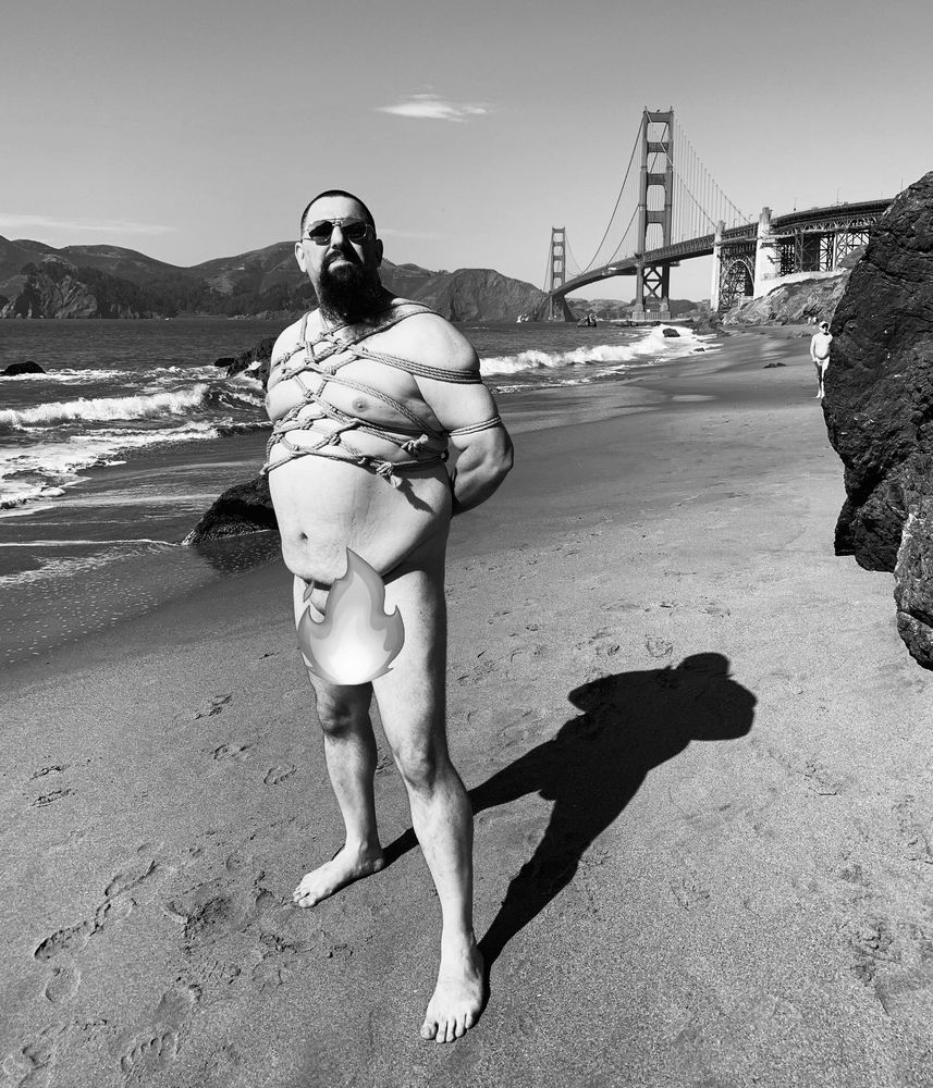 Rope on a male body standing in front of the Golden Gate Bridge