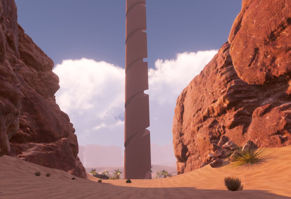 A VR world featuring a rocky canyon in the desert. A large tower spirals upwards, tall enough that its top is out of frame. A tent and the tops of some palm trees can be seen in the background.
