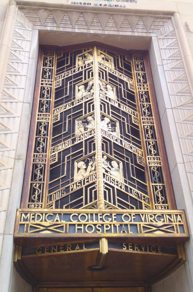 Ornate golden window, 2-stories tall, showing 8 medical pioneers, each in his own pane, with name across pane bottom. At bottom of window: MEDICAL COLLEGE OF VIRGINIA HOSPITAL, GENERAL SERVICE.