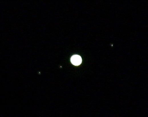 Jupiter overexposed but with three moons visible in orbit.