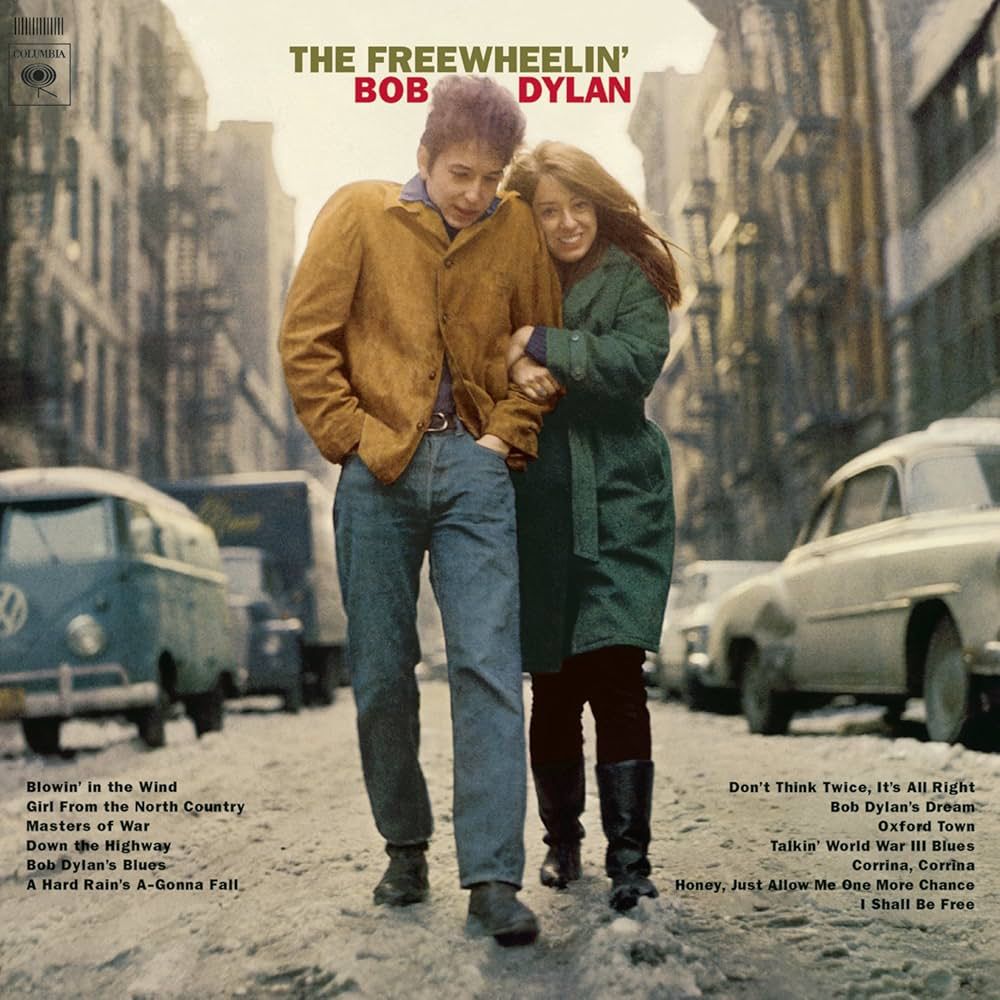 Cover of ‘the freewheeling Bob Dylan’ record, featuring Bob and girlfriend walking down a street in Greenwich Village.