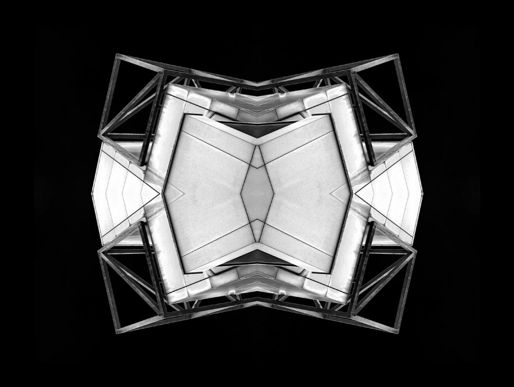 An abstract architectural image that has been reflected both horizontally and vertically to create a perfectly symmetrical object.