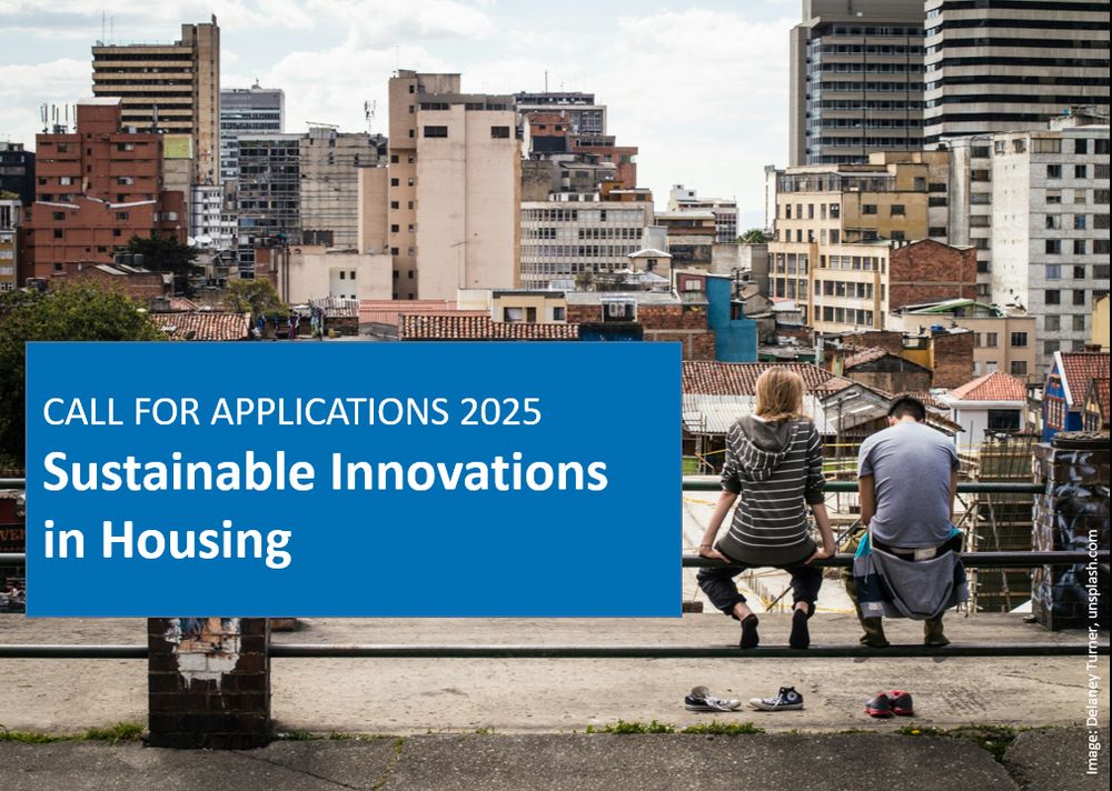 A man and a woman sit on a railing with their backs to the viewer, looking down on a city. In the foreground a banner: "Call for Applications 2025, Sustainable Innovations in Housing"