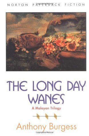 Cover of Norton paperback Fiction edtion of The Long Day Wanes, A Malayan Trilogy, by Anthony Burgess. The illustration is a painting, by an unnamed artist, showing what appears to be the recumbent body of a sleeping Malaysian man, perhaps 30 years old. His head and chest cavity are split open and full of flowers. His torso blends into the clouds in the sky. 