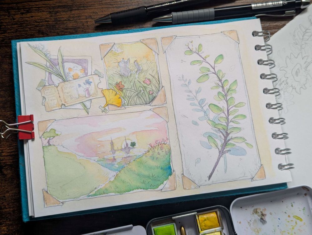 Photo of a sketchbook with tools around it. 
There's a mixture of watercolour sketches that are made to look like a travel scrapbook. 
Some of the sketches feature plants, a few sunset scenes and cats.