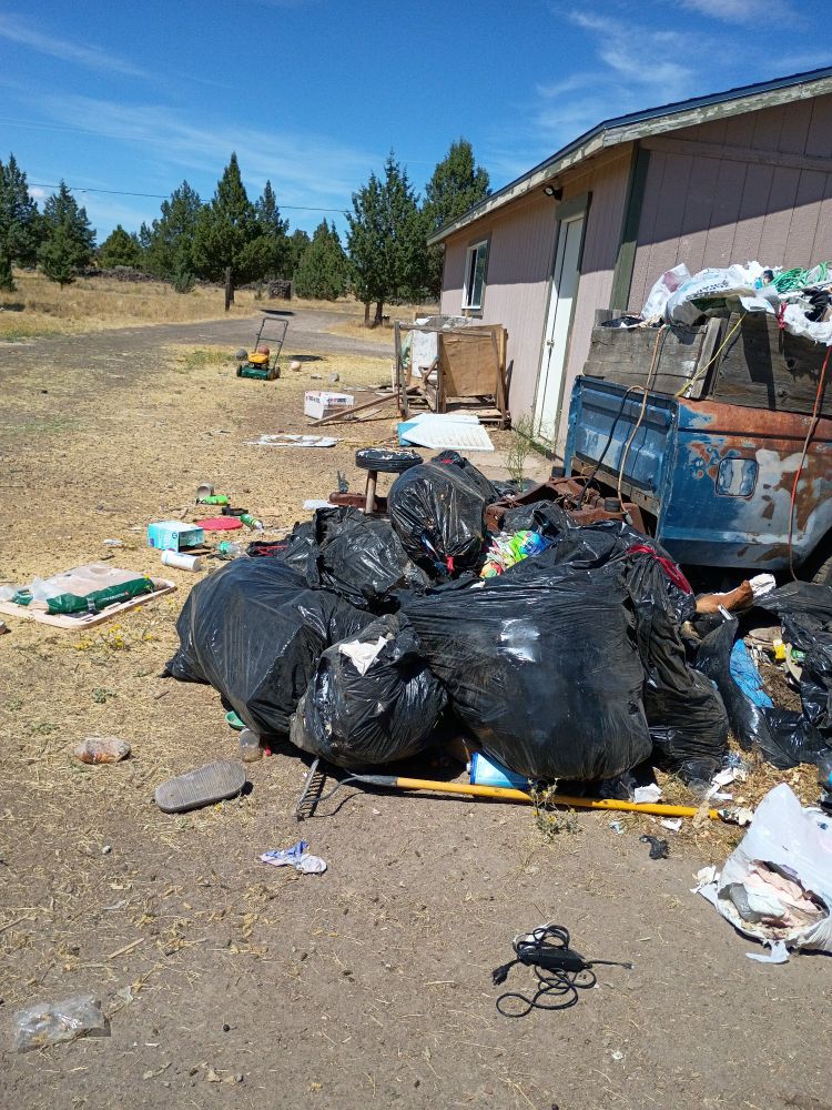 17 30 gallon trash bags, stacked to go to the dump.