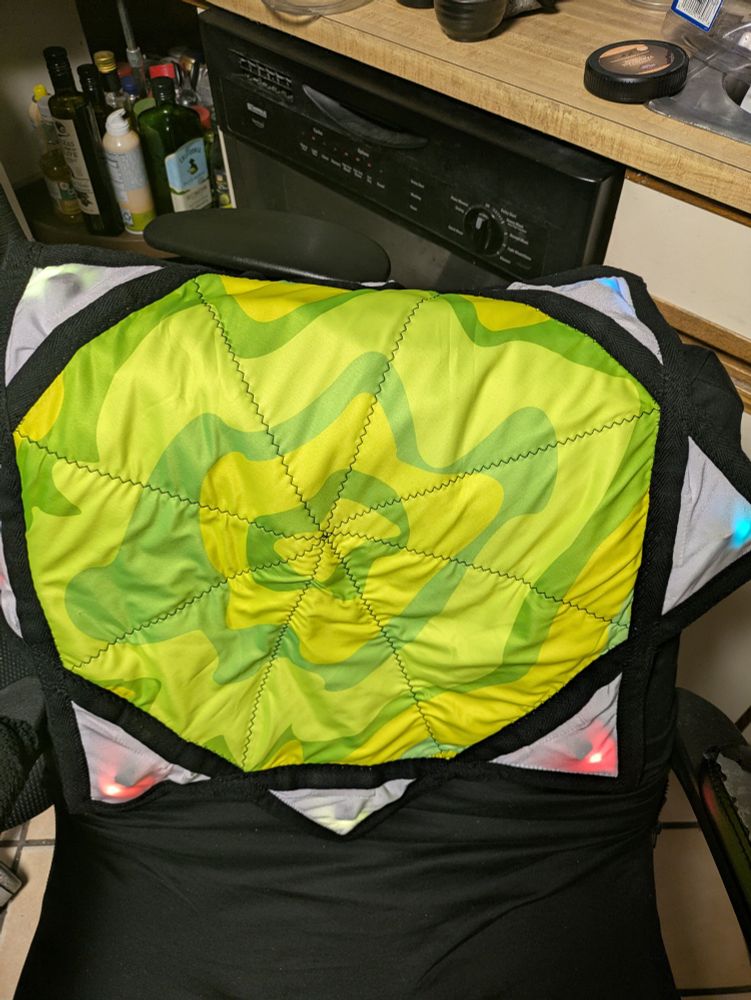 A picture of the glowstar lit by white light to show the lime green and yellow fabric pattern on it.
