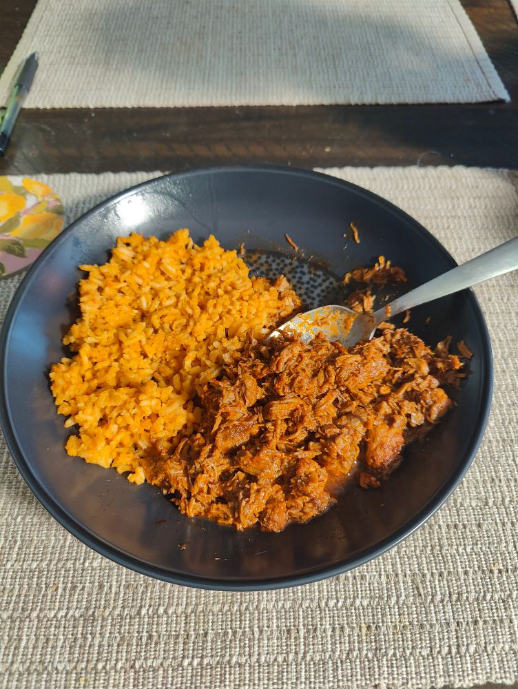 A plate of chile colorado with Mexican rice.