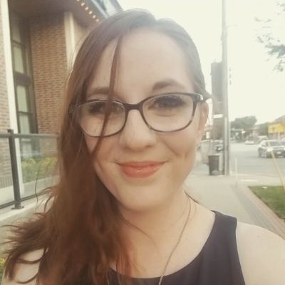 Picture of me from a few years ago, intense makeup, smiling with a filter on the image.