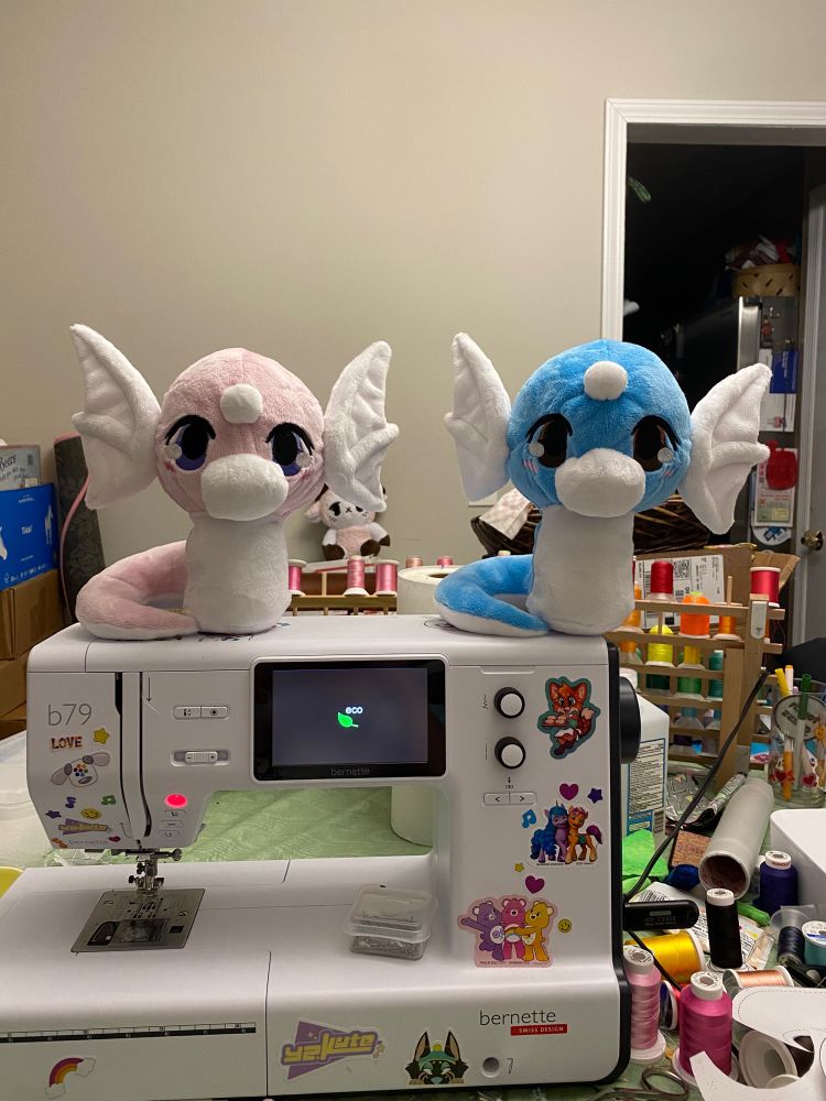 A shiny dratini and regular dratini on top of a sewing machine