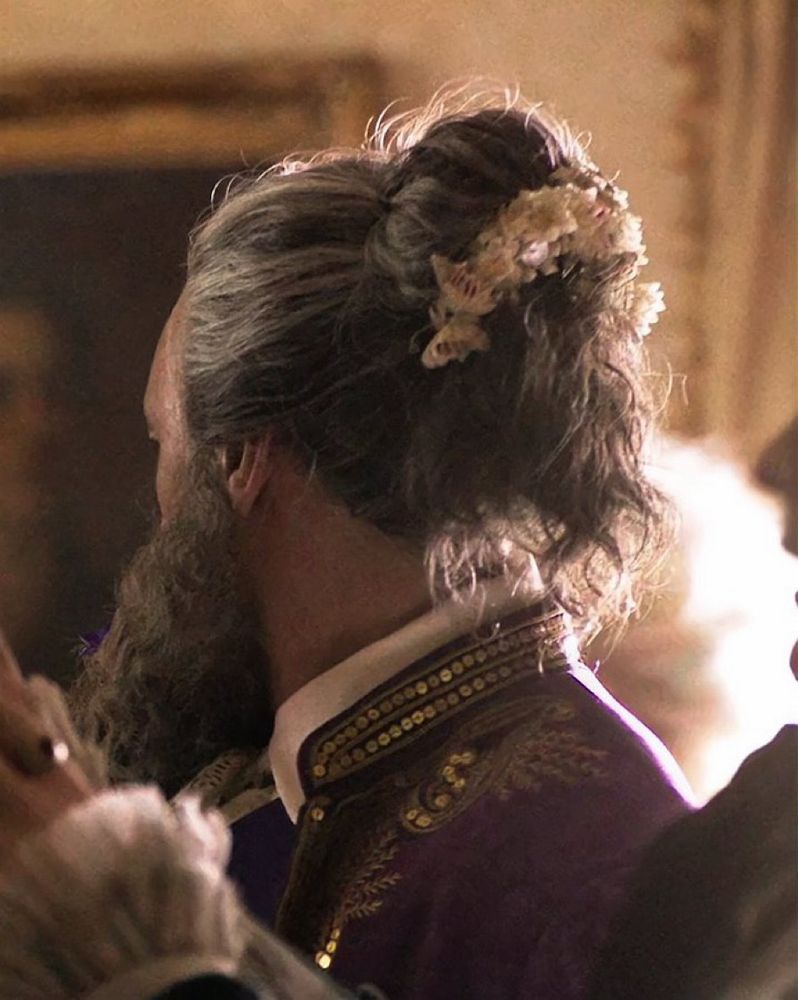 Back of Edward Teach’s head at the hoity toity boat party in a classy updo with butterfly decorations 