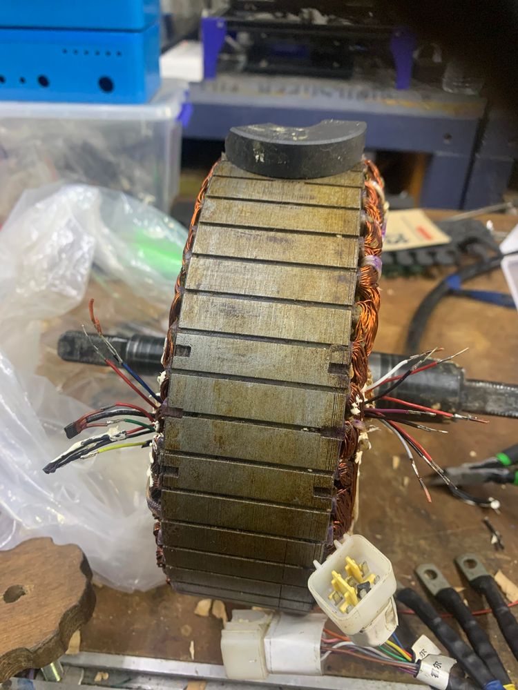 Wide shot of a motor hub showing slots where magnetic field sensors are placed.  These let the motor controller know when the motor is in position for the next cycle of the three-phase coil-energization pattern.