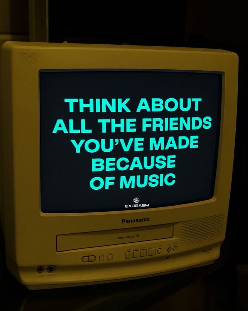Image of a computer screen with blue-green type saying “think about all the friends you’ve made because of music”