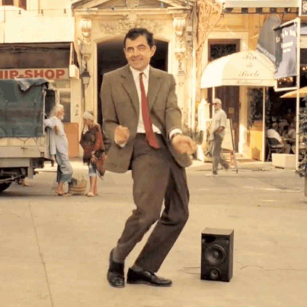 a man in a suit and tie dancing in front of a hip-shop